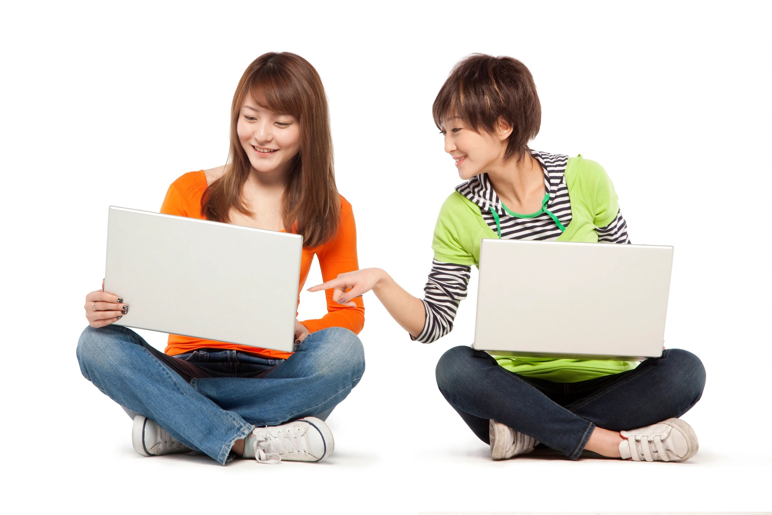 Two women holding grey laptop for high performance.