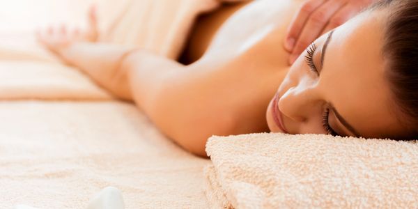 Woman enjoying a relaxing back massage at a spa.