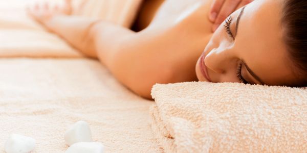 Woman enjoying a relaxing back massage at a spa.