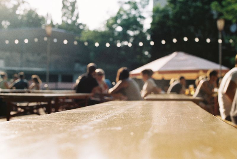 Beer garden table and people in background.