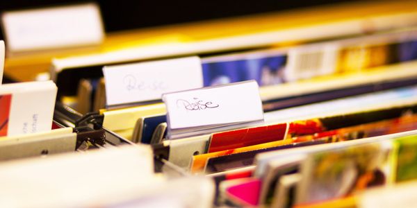 Colorful folders with labels organized in a filing system.