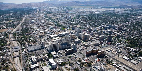 Aerial view of a sprawling city with urban buildings and highways.