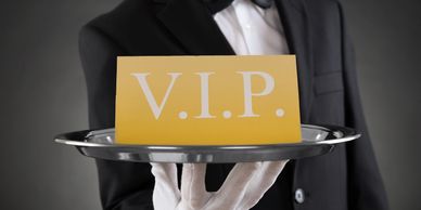 Waiter holding a VIP card on a silver tray.