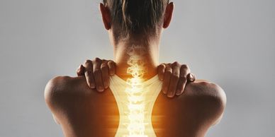 Woman with glowing spine illustration, highlighting back health.
