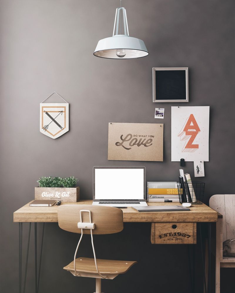 Stylish workspace with computer and posters on home or studio