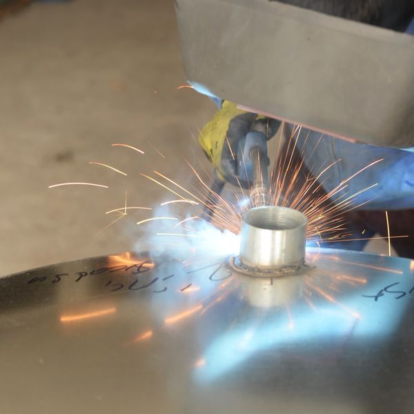 Close-up of welding sparks on a metal surface.
