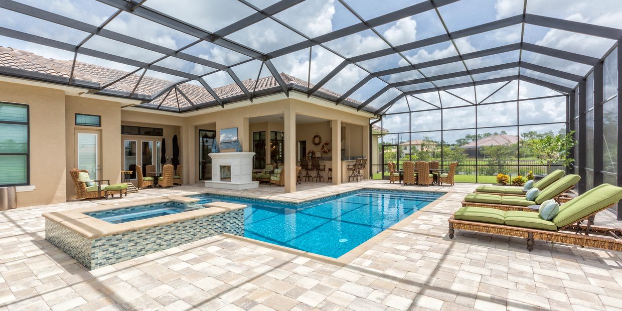 Spacious screened pool area with lounge chairs and outdoor seating.