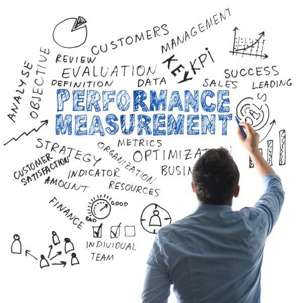 Man writing business strategy keywords on a whiteboard.