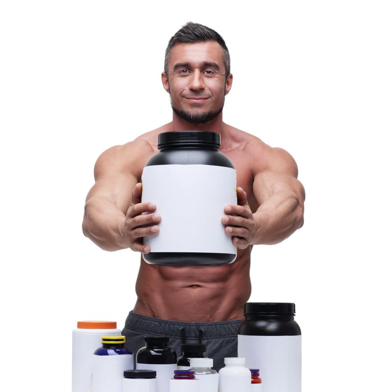 Portrait of a happy muscular man with sports nutrtion