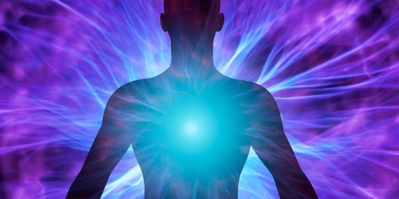Silhouette with radiant energy glowing from the chest against a purple-blue background.
