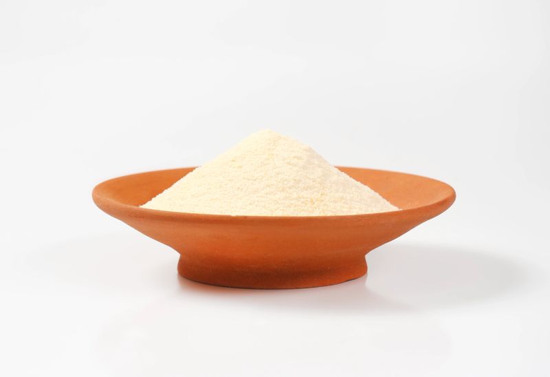 Heap of semolina flour on a ceramic plate