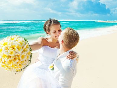 A newly married couple romancing on the beach in the maldives