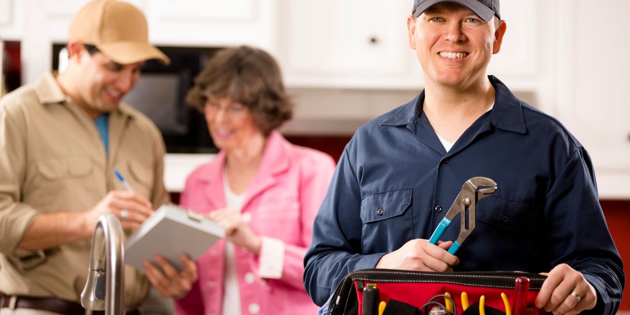 Water damage restoration technician assisting homeowners during the restoration process.
