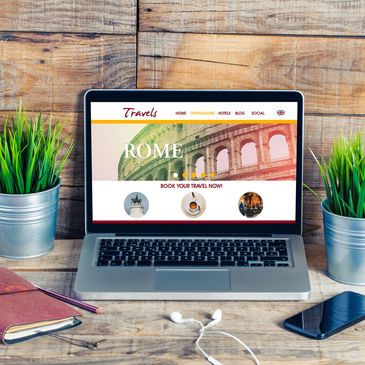 Laptop displaying a travel website for Rome on a wooden desk.
