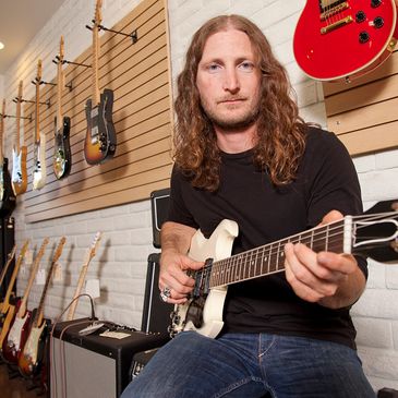 a man playing a used guitar