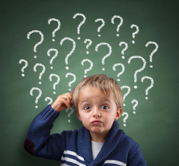 Confused child scratching head with question marks behind.