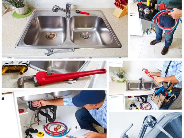 Plumber fixing a kitchen sink with various tools and pipes.