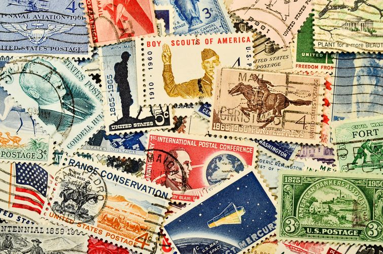 A colorful collection of vintage U.S. postage stamps with various historical themes.