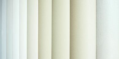 Various neutral-colored fabric rolls.