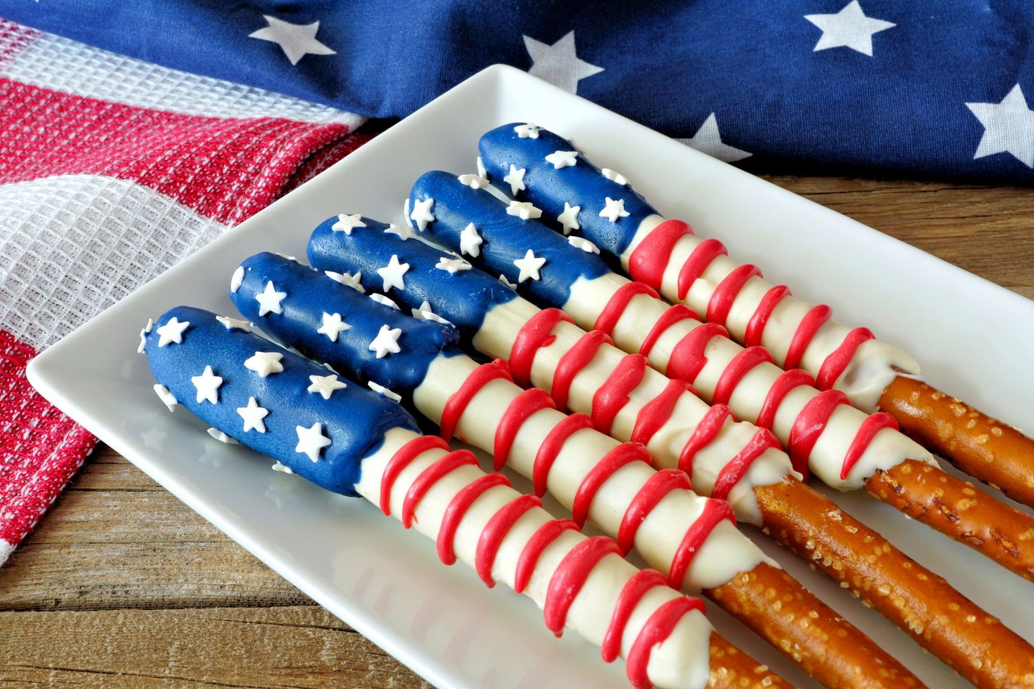 Pretzel sticks decorated like the American flag with blue, white, and red icing.