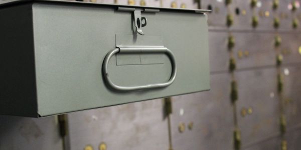 A close-up of a metal safety deposit box handle.