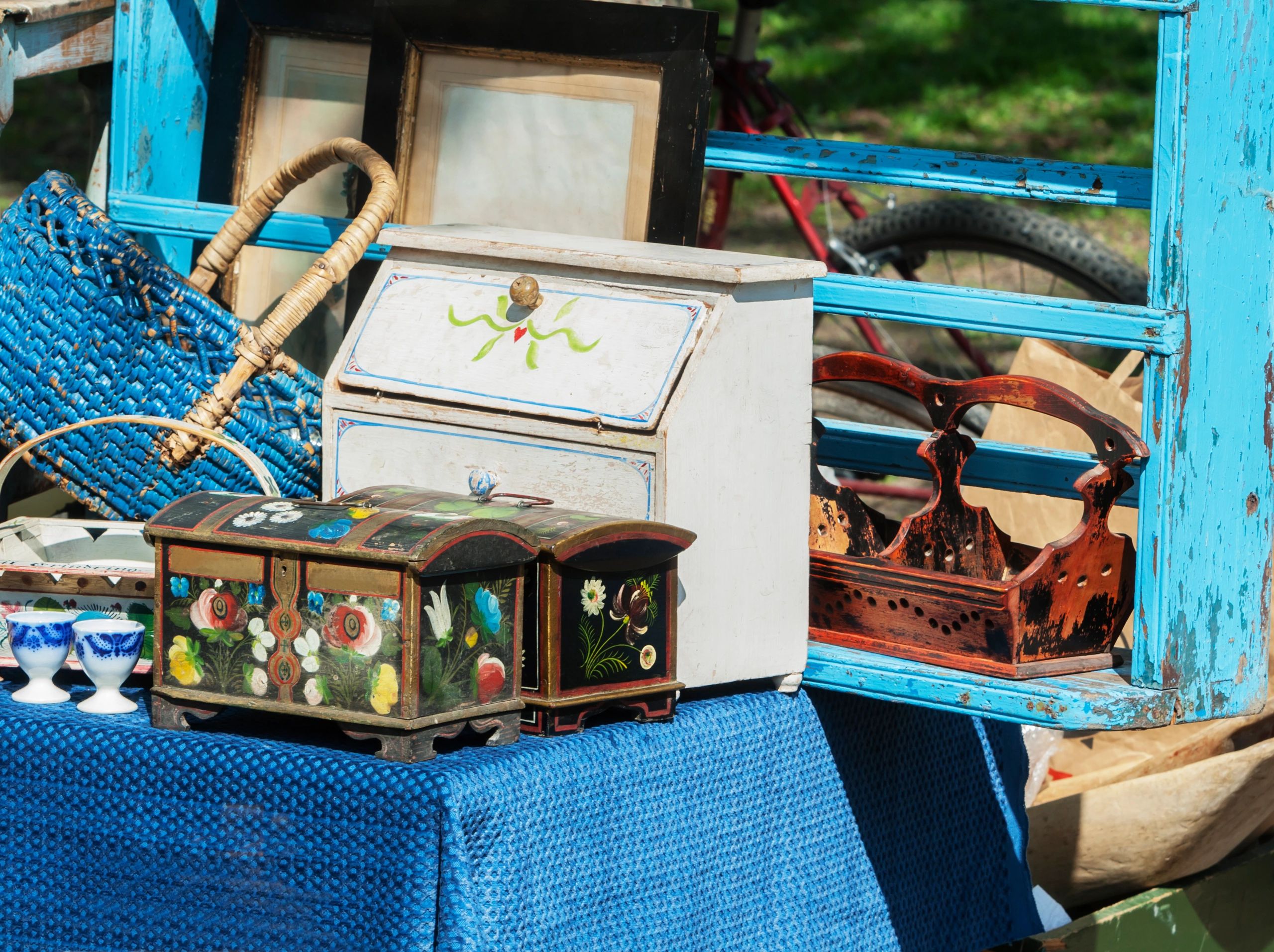 Vintage wooden boxes and woven basket on blue cloth.