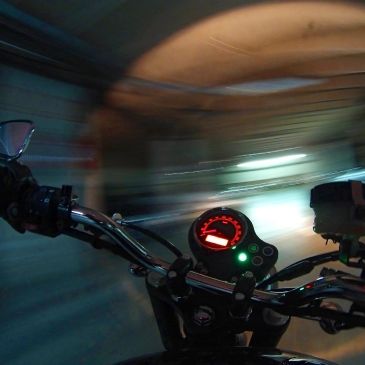 Motorcycle speeding through a tunnel.