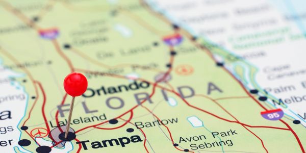 Red pin marking Tampa on a Florida map.