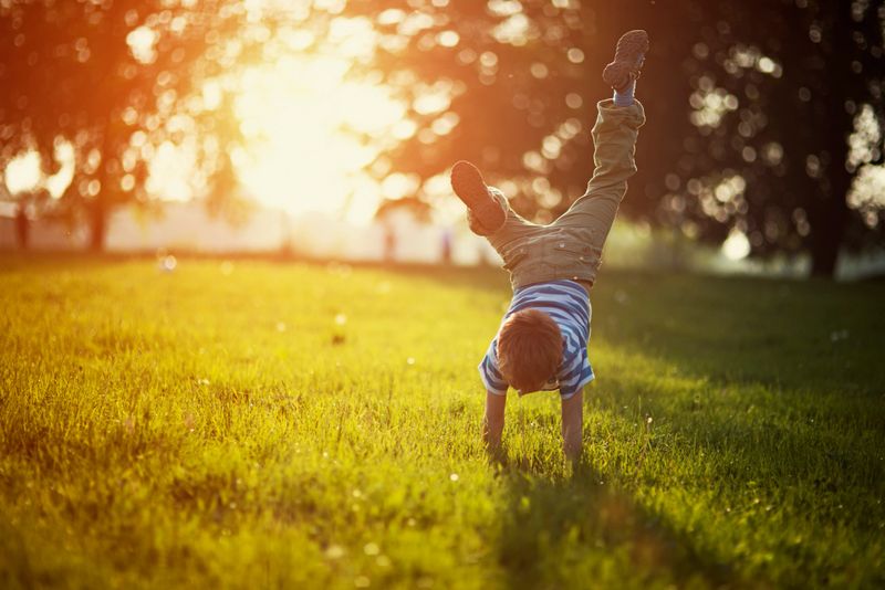 A joyful child leaping in a vibrant park, capturing the essence of childhood and playfulness.
