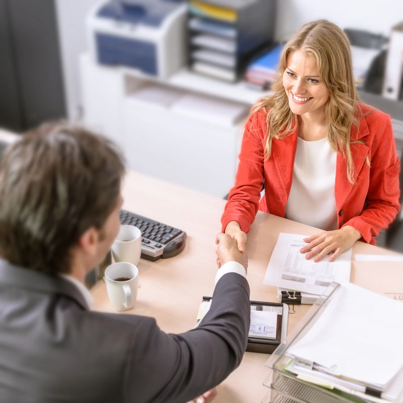Male and female business people shaking hands