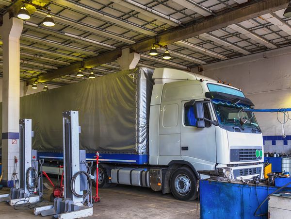 Commercial HGV truck in workshop during inspection and truck diagnostics process