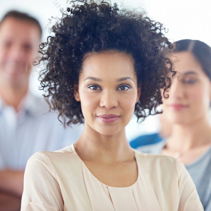 Portrait of a beautiful woman with her colleagues in the background