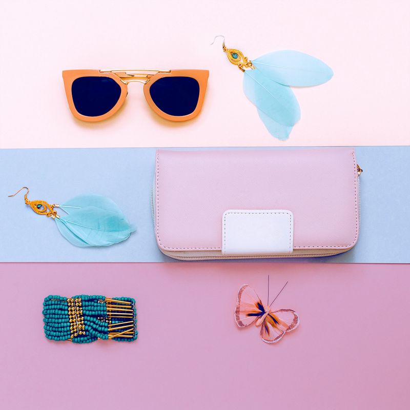 Ladies Fashion Accessories. Pink Clutch, sunglasses and jewelry. Pastel colors Trend