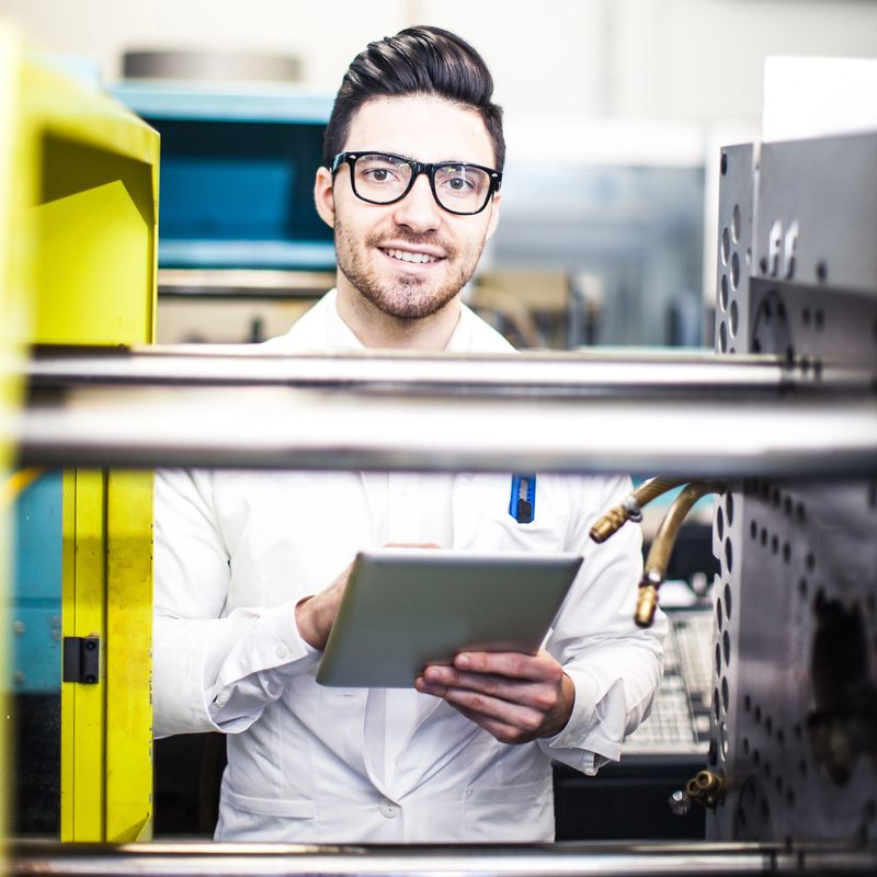 Young engineer holding digital tablet in the factory