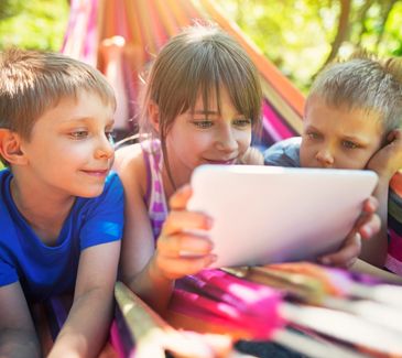 Kids playing Nerf in outdoor fun.