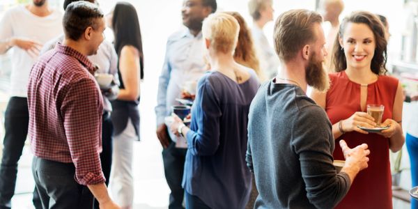 People socializing and enjoying drinks at a casual gathering.