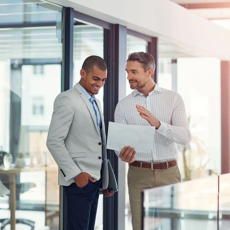 Shot of businessmen talking over some paperwork in an office