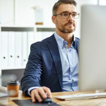 Man working at a computer in an office.