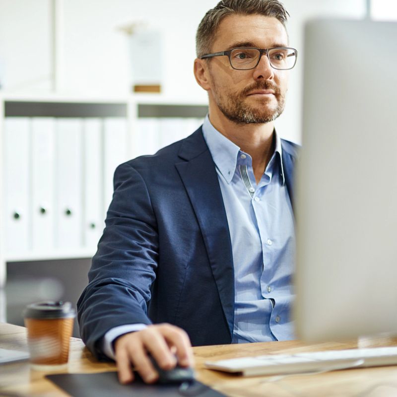 Shot of a mature businessman using a computer at his desk in an office