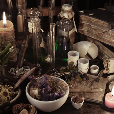 An old apothecary table with dried herbs, candles, glass bottles, and ancient books.