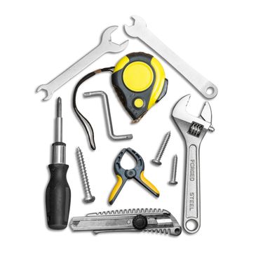 Various hand tools arranged in the shape of a house on a white background.