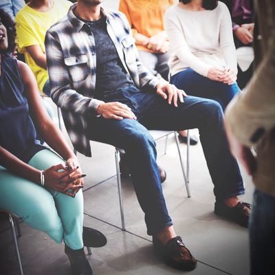 People sitting attentively in a casual group setting.