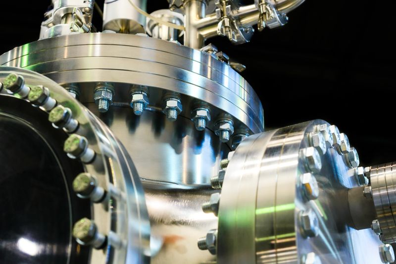 Flanged vacuum equipment. Shiny metal surface. A metal surface treated.