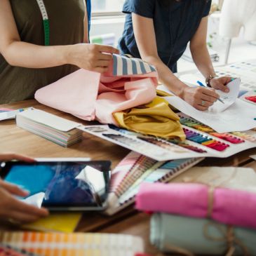 Designers working with fabrics and color swatches.