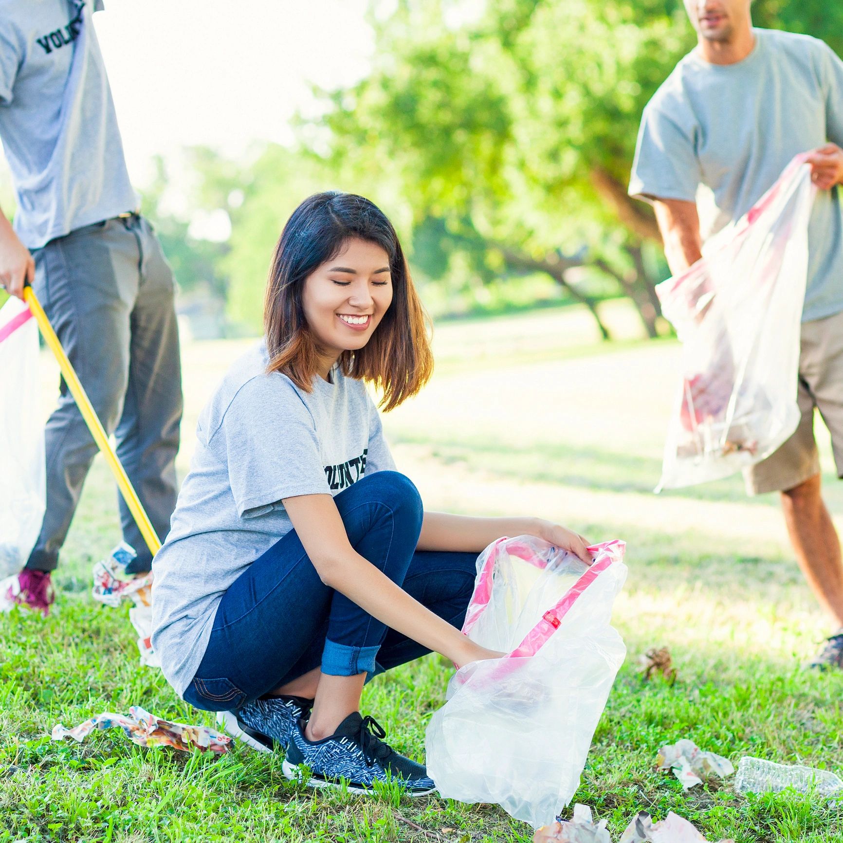 Volunteers cleaning up litter in a park.