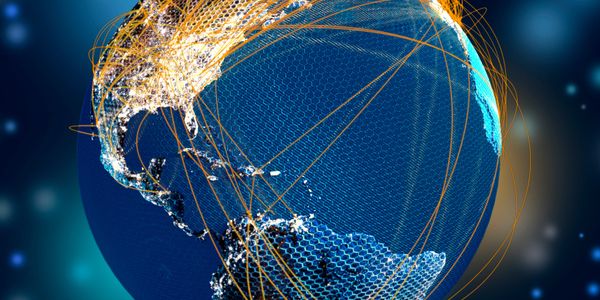 Digital globe with illuminated North and South America connected by orange network lines.
