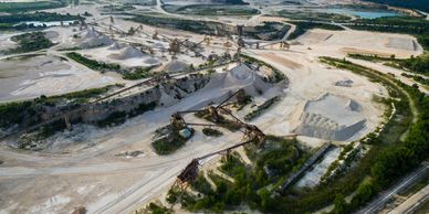 A vast limestone quarry with conveyor belts and machinery.