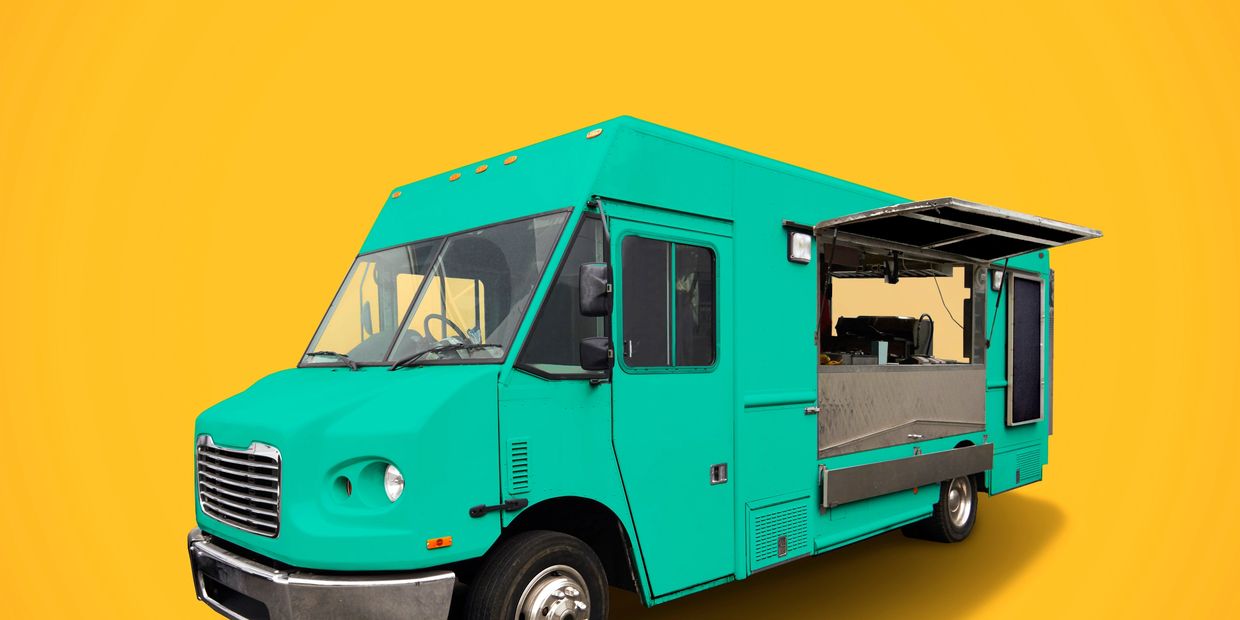 Teal food truck with open service window against a bright yellow background.
