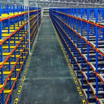Empty warehouse shelving with blue and yellow racks.