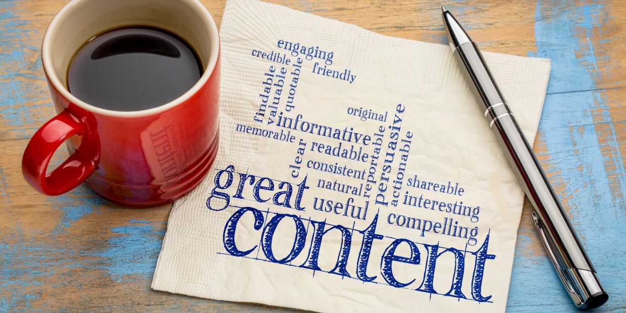 Napkin with positive content-related words, coffee cup, and pen.